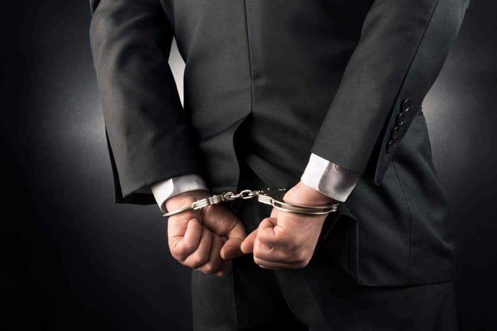 Businessman is arrested and handcuffed high quality and high resolution studio shoot