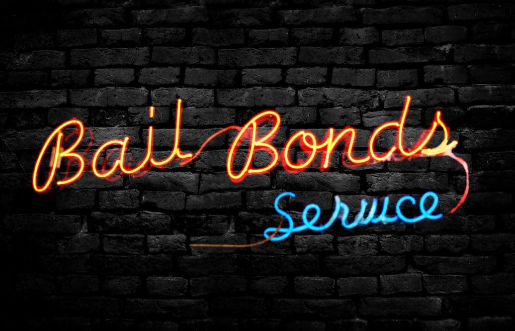 Neon Bail Bonds Service sign on a brick wall